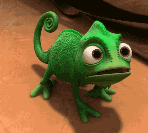 A foto mostra o pequeno camaleão verde, Pascal, com os olhos arregalados e boca aberta.