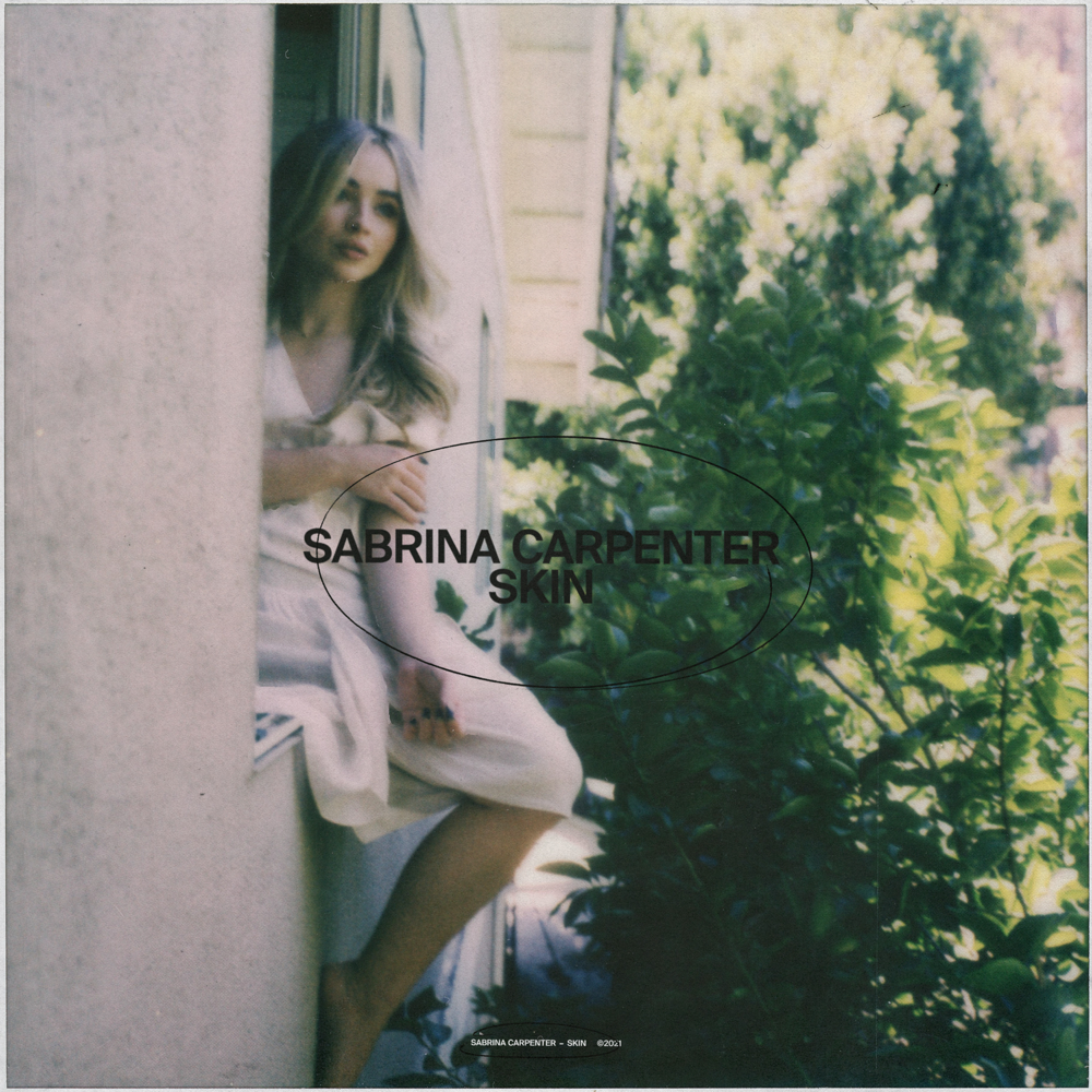 Na capa do single Skin, Sabrina, uma mulher branca e loira, se encontra sentada na janela de uma construção de paredes brancas. Do seu lado, há uma árvore onde algumas folhas brilham ao refletir a luz do sol.