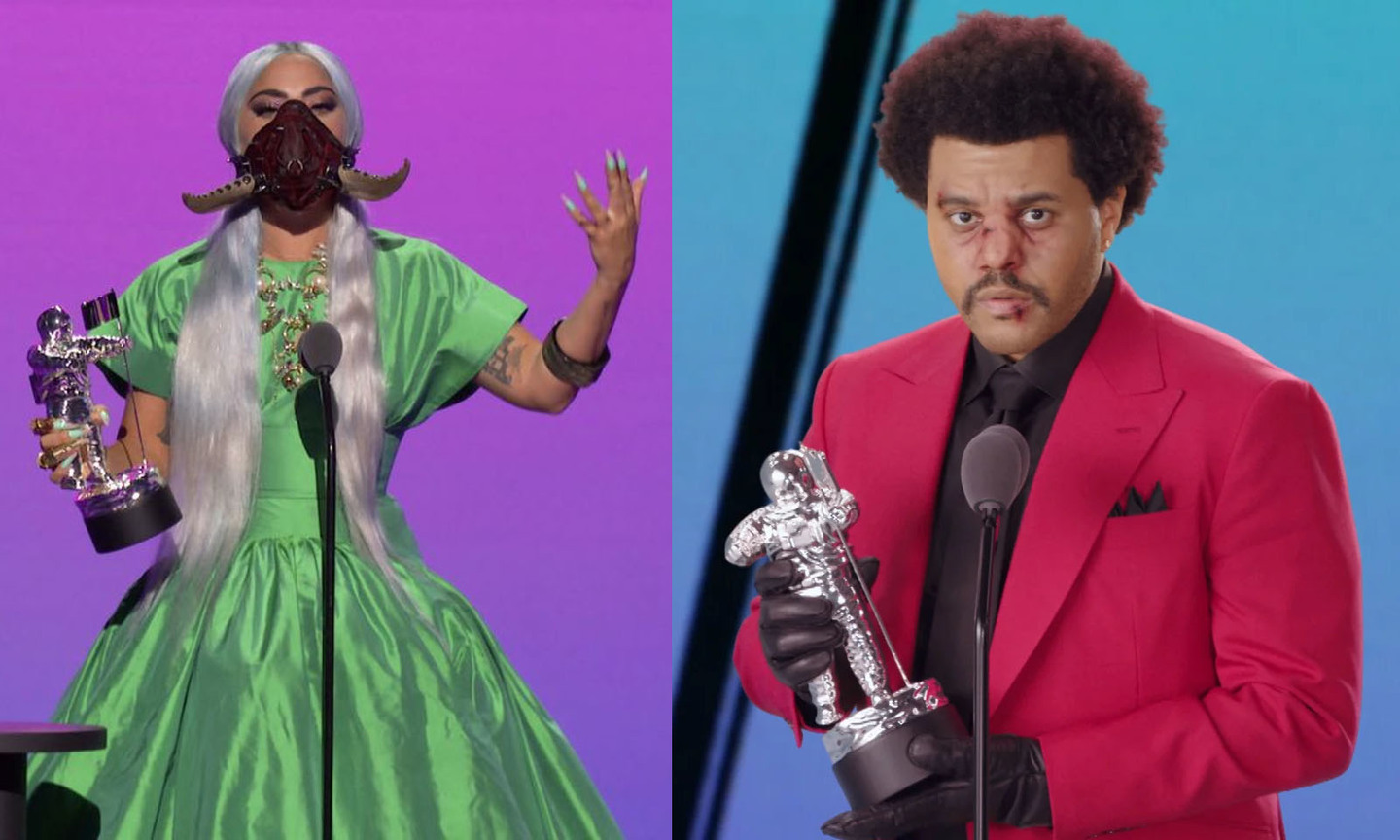 Descrição: Do lado esquerdo, a cantora Lady Gaga - aparece com um vestido verde de tafetá de seda, máscara exótica vermelha queimada/preta com dois chifres, com o cabelo platinado, longo e praticamente liso, ela também tem como acessórios: diversos anéis dourados, um bracelete no braço esquerdo e colares dourados - segurando com a mão direita um dos seus 5 prêmios no VMA 2020. Do lado direito, o cantor The Weeknd usando blazer vermelho, camisa, gravata e luvas pretas; cabelo crespo com penteado black, rosto maquiado com alguns ferimentos na área da boca e nariz. Ele segura o prêmio do VMA com as duas mãos pendendo para o seu lado direito. 