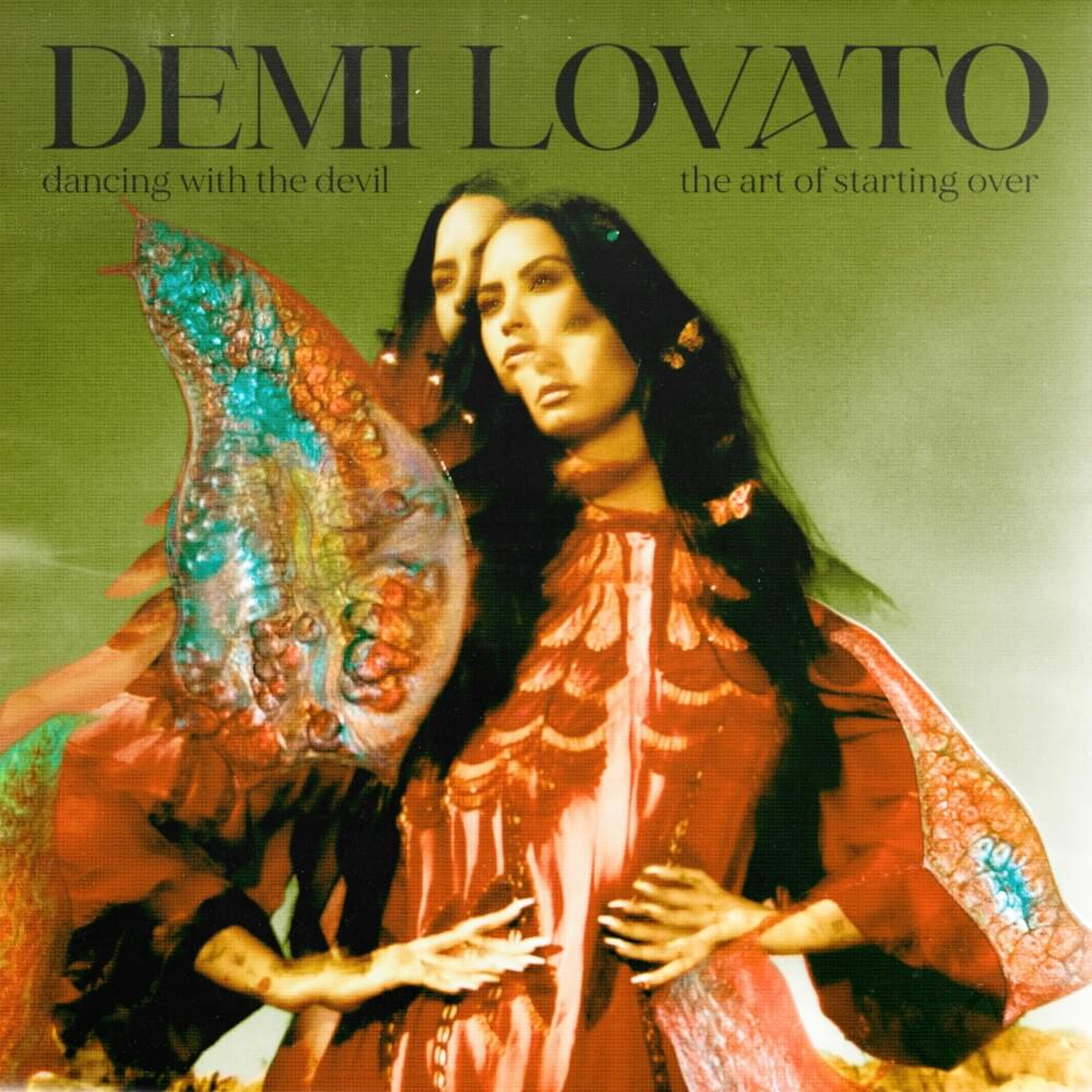 Capa do álbum 'Dancing With The Devil... The Art of Starting Over', de Demi Lovato. Nela, Demi Lovato está com as mãos em sua cintura, e ela usa um vestido kimono vermelho. A imagem é holográfica, e o corpo de Demi se repete três vezes sobre a o fundo verde. Seus cabelos são longos, na altura de sua costela, e sob suas madeixas existem pequenas borboletas de acessório.