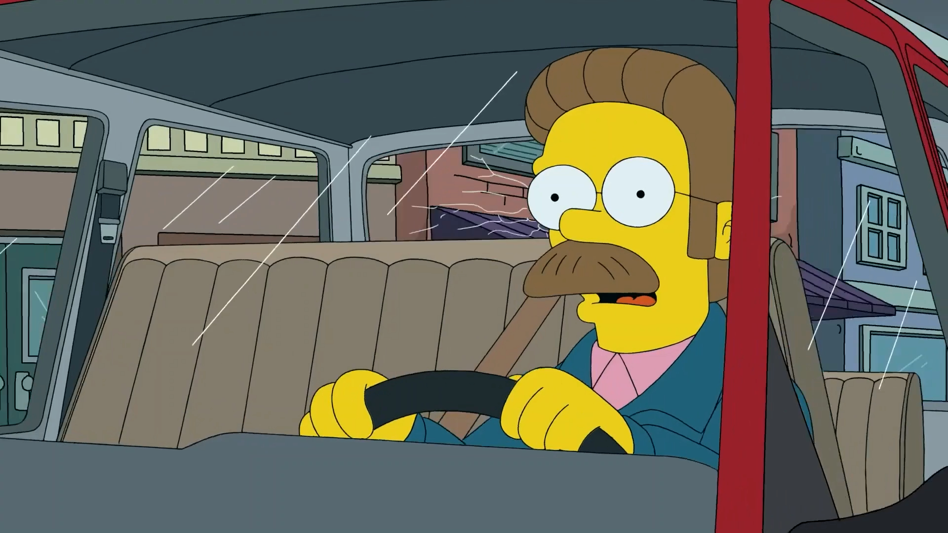 Cena da 33ª temporada de Os Simpsons em que Ned Flanders, um personagem de animação com a pele amarela, cabelos e bigodes castanhos, óculos redondos e casaco verde, demonstra espanto enquanto dirige um carro danificado.
