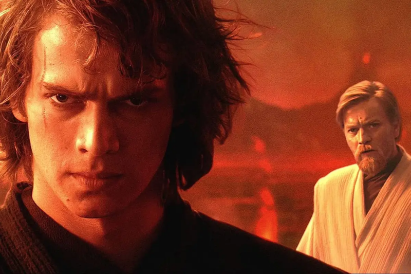 O cenário é um planeta cheio de lava. A iluminação é predominantemente vermelha. Na parte esquerda, em primeiro plano, está Anakin, ele olha em direção a câmera expressando ódio. A parte direita do seu rosto está iluminada, e a outra metade está pouco iluminada. Do lado direito, ao fundo, está Obi Wan. Ele olha com certa preocupação para Anakin.
