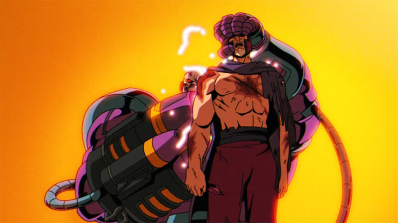 Cena de X-Men ‘97Na imagem, Apocalipse segura Magneto pela cabeça enquanto aponta uma arma embutida na mão direita. O vilão é forte e grande, na cor roxa e azul, ele possui cabos e peças de máquina pelo corpo. Ele sorri de forma sádica. Já Magneto, é um homem branco que usa um capacete roxo na cabeça. Também veste capa e calças da cor roxa. Ele está gritando em agonia e tem peito e braços machucados. No horizonte, a luz do sol, laranja, está bem forte e cobre todo o cenário. 